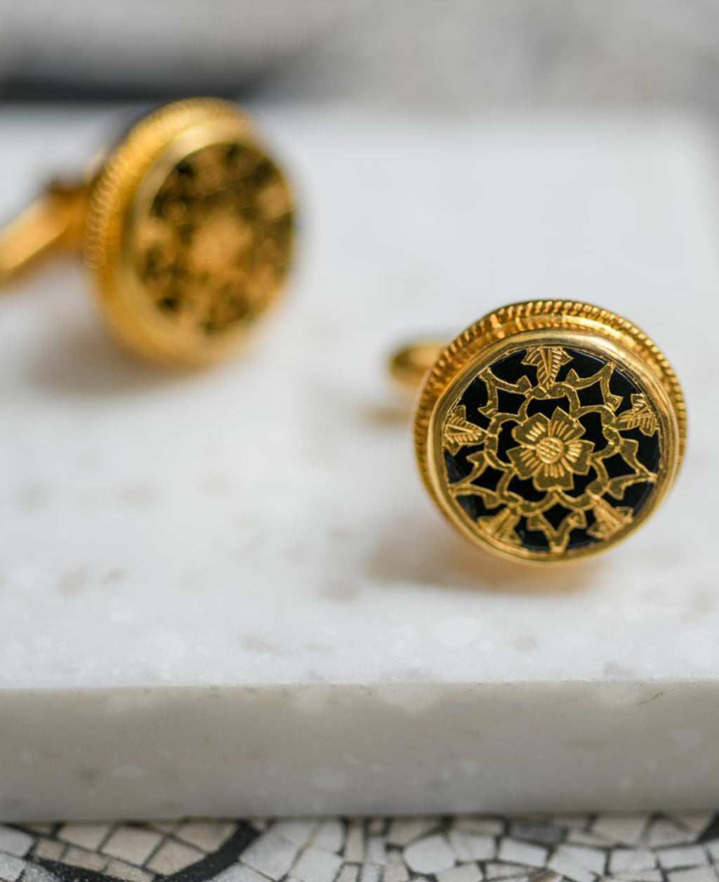 Black intricately hand-carved thewa work on the gold sheet