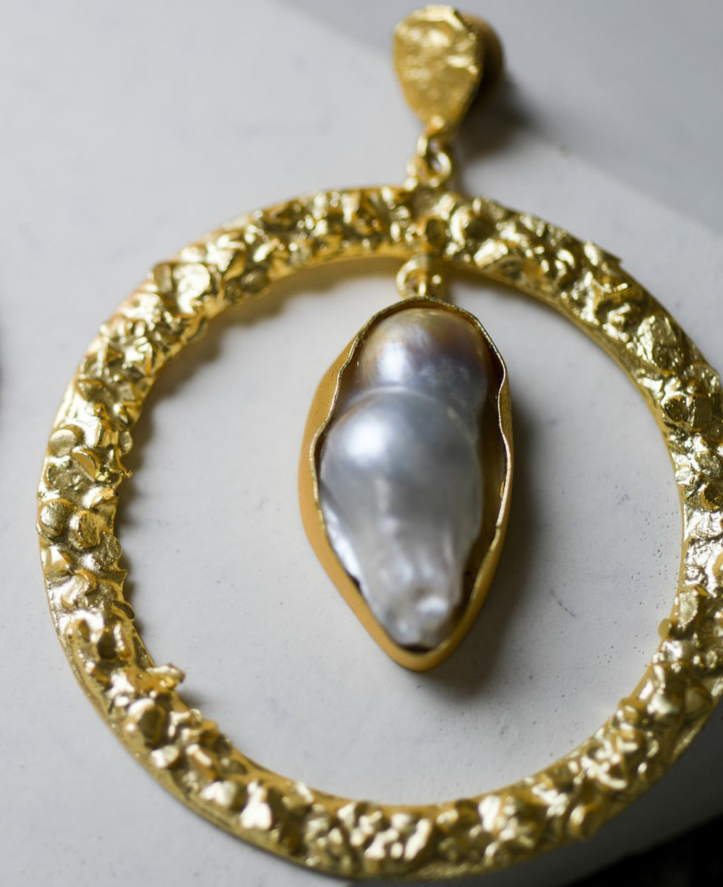Single drop-in round textured brass earrings