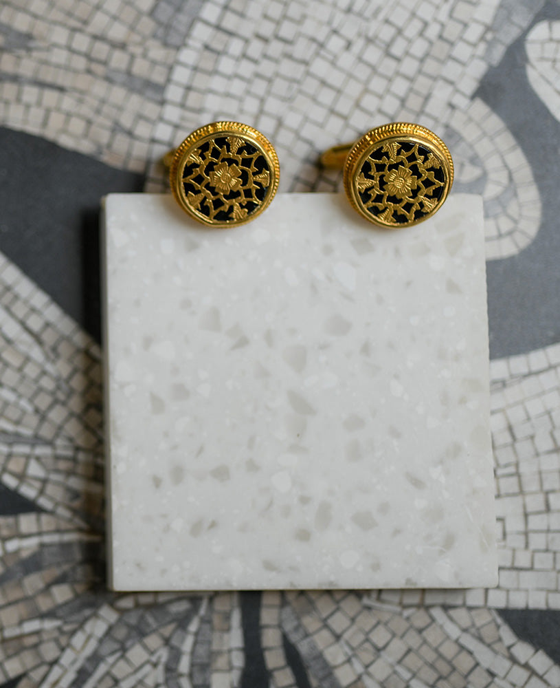 Black intricately hand-carved thewa work on the gold sheet