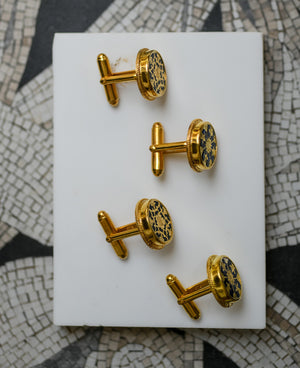Black intricately hand-carved thewa work on the gold sheet